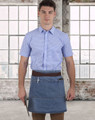 A denim half apron with a brown waistband, worn by a person in a blue checked shirt, against a city skyline backdrop.