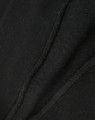A close-up view of a black crew fleece sweat, highlighting its textured fabric and stitching details.