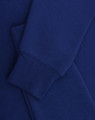 A blue crewfleece jumper featuring a close-up of the sleeve and cuff details. It has a small logo.