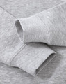 A grey crew fleece sweater featuring long sleeve cuffs and a soft texture, with a logo present.