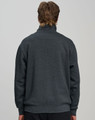 A grey 1/2 zip collar fleecy jumper with a relaxed fit, featuring a branded logo on the back.
