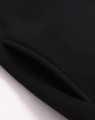 A close-up of a black polar fleece jumper featuring a 1/2 zip collar, with a smooth texture and a visible seam.
