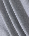A close-up of light grey fabric, showcasing the soft texture of a fleecy material.