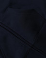 A close-up of a navy blue kid's full-zip fleecy hoodie featuring a kangaroo pocket and a logo.