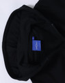 A black full-zip fleecy hoodie with a hood and a label inside.