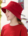 A red bucket hat with a toggle feature, worn by a child, alongside a matching red shirt. The hat has a logo.