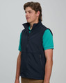 A men's softshell vest in navy blue, featuring a zip front and side pockets, worn over a green shirt.