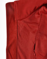 A red softshell vest featuring a smooth exterior and a textured interior, with a zippered pocket and a logo.