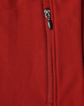 A close-up of a red softshell vest featuring a zippered pocket and a logo.