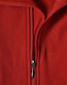 A red softshell vest with a zippered front and a fleece interior, featuring a logo.