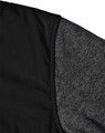 A black quilted jacket featuring a heather grey sleeve. Includes a logo on the fabric.