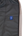 A men's waterproof performance jacket in grey with a mesh lining and a visible interior label.
