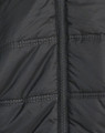 A close-up of a black, unisex sustainable parka jacket featuring a seamless design and zip closure.