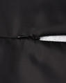 A close-up of a black parka jacket featuring a zipper and seamless design. It includes a logo on the fabric.