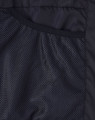 A close-up of the interior lining of a black sustainable parka jacket featuring a mesh texture.