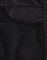 A close-up of the interior of a black insulated puffer jacket, featuring mesh pockets.