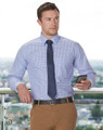 A men's long-sleeve shirt in a blue and white gingham check pattern, paired with a navy tie and beige trousers.