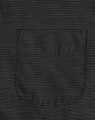A close-up view of a black pin dot fabric featuring a pocket, showcasing a textured pattern.