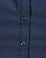 A navy blue button-up shirt with a pin dot pattern and blue buttons. Features a textured fabric design.