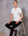A white ladies' V-neck short-sleeve knit top is worn with black pants, featuring a logo. Model seated on a bar stool.