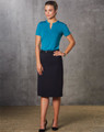 A fitted navy A-line utility skirt paired with a teal top, styled with high heels against a textured background.