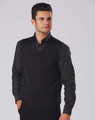 A men's black 100% Merino wool V-neck vest worn over a dark shirt, featuring a fitted design.