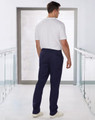 Men's solid colour scrub pants in navy blue, featuring an elastic waistband and a plain back view.