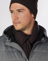 A man wearing a dark brown cable knit scarf, paired with a grey jacket and matching beanie.