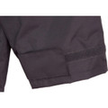 A close-up of a black safety jacket featuring a Velcro patch and reflective 3M tape accents.