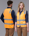A fluorescent orange safety vest with reflective stripes, shown worn by two models from front and back.