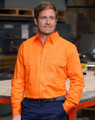A bright orange men's long-sleeve drill shirt with two front pockets and a logo, set against an industrial background.