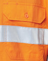 An orange safety shirt featuring a reflective silver tape and a pocket with an orange button.