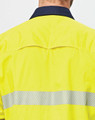 A high-visibility yellow long-sleeve shirt with segmented reflective tape on the back and a navy collar.
