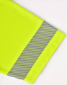 A bright yellow polo shirt featuring a segmented reflective strip on the sleeve. It has a logo on it.