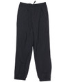 Black track pants with an elastic waistband and drawstring, featuring side pockets and a subtle logo.