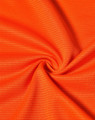 An orange fabric featuring a textured pattern, suitable for lightweight performance t-shirts.