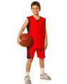A red kid's basketball singlet and shorts set, featuring black accents, held by a child with a basketball.