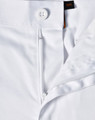 A close-up view of white unisex utility stretch cargo work pants showcasing the waistband and button detail.