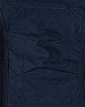 A close-up of dark navy rip-stop poly/cotton stretch work pants, featuring textured fabric and detailed stitching.