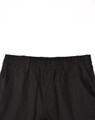 Black unisex cotton stretch drill cuffed work pants featuring an elastic waistband and pockets.