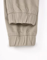 A pair of unisex cotton stretch drill cuffed work pants in khaki, featuring elastic cuffs and a simple design.