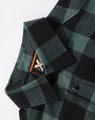 A green and black plaid unisex flannel shirt featuring a button-up design and a collar. It has a logo label inside the collar.