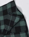 A unisex flannel plaid shirt featuring green and black check patterns, with button-up details and a logo.