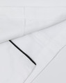 A unisex executive chef jacket in white with black detailing and a logo on the fabric.