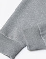 A grey unisex crew neck sweater displayed at an angle, highlighting the cuff detail. The fabric appears soft and textured.