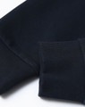 A close-up of a navy unisex crew neck sweater featuring ribbed cuffs and a smooth finish. Contains a logo.