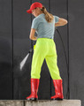 Lightweight nylon waterproof rain pants in bright yellow, paired with red boots, worn by a person washing a surface.