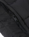 A close-up of a black insulated puffer vest featuring a zipper and quilted fabric texture.