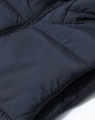 Men's sustainable insulated puffer vest in navy, featuring a soft, textured fabric and a zip closure.