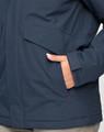 A unisex quilted waterproof jacket in navy blue, featuring a pocket and a close-up of the material.